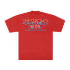 A red short-sleeve t-shirt shown from the back, featuring a graphic print with the text 'THE STROKES' in white outlined letters, 'Rolling Animals' in blue script, 'New York' in orange, and additional blue text below, displayed on a solid white background.