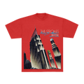 A red short-sleeve graphic t-shirt featuring a stylized art deco illustration of the New York City skyline, with 'THE STROKES' and 'NEW YORK' printed across the chest.