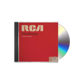 The album artwork for The Strokes' Comedown Machine CD is displayed flat against a plain, The cover mimics a vintage RCA magnetic tape box, featuring a bold, textured red background with a prominent yellow stripe down the left side and a classic, cream-colored RCA manufacturer label across the top. The album title is stamped in a minimalist, black sans-serif font across the center, giving the packaging a retro, analog media aesthetic.