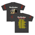 Front and back views of a dark charcoal gray short-sleeve t-shirt for the band The Strokes. The front features the THE STROKES logo in white text above a colorful graphic of a dekotora truck with red script text on both sleeves and 2026 tour dates down the back in yellow.