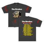 Front and back views of a dark charcoal gray short-sleeve t-shirt for the band The Strokes. The front features the THE STROKES logo in white text above a colorful graphic of a dekotora truck with red script text on both sleeves and 2026 tour dates down the back in yellow.
