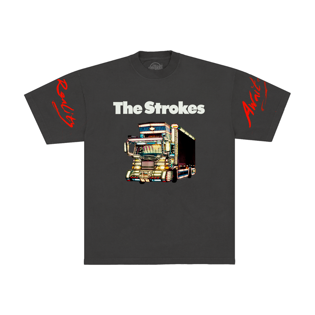 Dark grey t-shirt for the band The Strokes. The front features THE STROKES logo in white text above a colorful graphic of a dekotora truck with red script text on both sleeves.