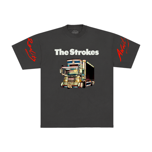 Dark grey t-shirt for the band The Strokes. The front features THE STROKES logo in white text above a colorful graphic of a dekotora truck with red script text on both sleeves.