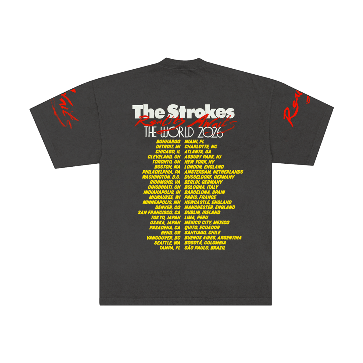 Dark grey t-shirt for the band The Strokes. Back of t-shirt features The Strokes Reality Awaits The World 2026 across the top with the 2026 tour itinerary in yellow down the back.
