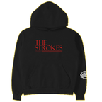 Black hoodie with 'The Strokes' text printed in red on the front across the chest and a white Strokes Chrome Logo on the left forearm. 